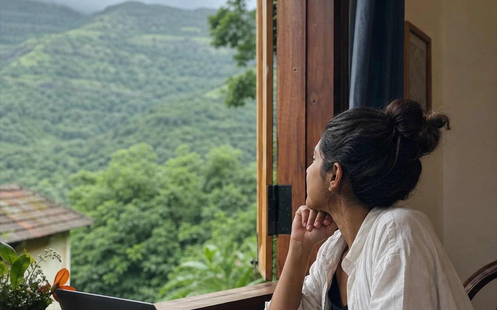 Traveller writing trip notes by a window